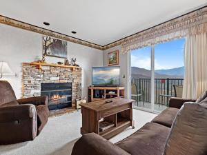 a living room with a fireplace and a television at Deer Ridge Mountain Resort D204 in Gatlinburg