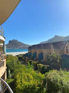 a view of the beach from a balcony of a building at On the Beach in Hout Bay