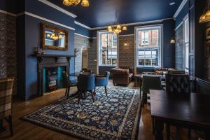 a living room with blue walls and a fireplace at The Pied Bull in Chester