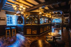 a bar with stools in a room with a bar at The Pied Bull in Chester