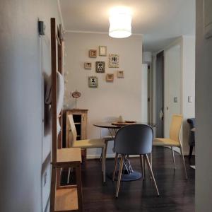 a kitchen and dining room with a table and chairs at Departamento Puerto Varas in Puerto Varas