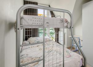 ein Metalletagenbett in einem Zimmer mit Fenster in der Unterkunft Triniteyt 0302 P7 in Nieuwpoort