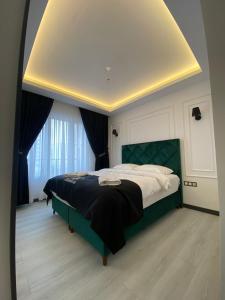 a bedroom with a green bed and a large window at X Premium in Kayseri