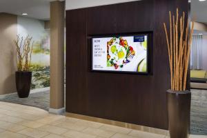 a flat screen tv on a wall in a lobby at Courtyard by Marriott Roseville Galleria Mall/Creekside Ridge Drive in Roseville