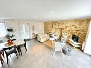 a living room with a table and a fireplace at Ti Nevez in Locmariaquer
