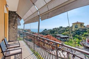 a balcony with chairs and a view of the ocean at Due passi dal mare tra gli ulivi in Varazze
