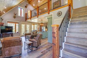 a home with a staircase and a living room at Riverfront Mountain View Cabin with Deck and Grill! in Mountain View