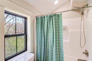 a bathroom with a shower curtain and a window at Riverfront Mountain View Cabin with Deck and Grill! in Mountain View +30 photos
