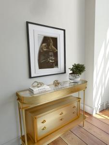 a table with a picture on a white wall at Stylish 3 Bedrooms in London