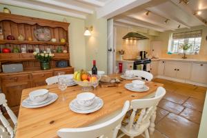 a kitchen and dining room with a wooden table and chairs at 5* Family Holiday Home in the Yorkshire Wolds in Huggate
