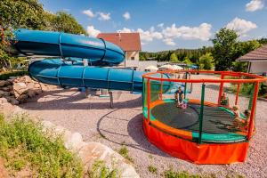a playground with a slide in a park at Budget Glamping Safaritent La Sténiole in Barbey-Séroux