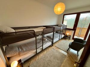 a room with two bunk beds and a chair at Felix Villa in Nyíregyháza