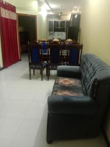 a living room with a couch and a table at Gujrat Guest House in Gujrāt