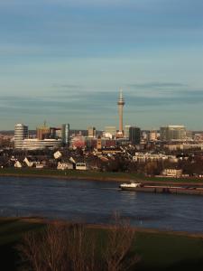 a view of a city with a river and a city at Crowne Plaza Düsseldorf - Neuss, ein IHG Hotel in Neuss