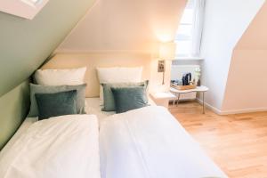 Voodi või voodid majutusasutuse Sixtus Sinatur Hotel & Konference toas
