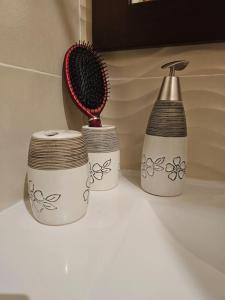 a hair brush and two cups on a counter at Sweet Memories in Sousse