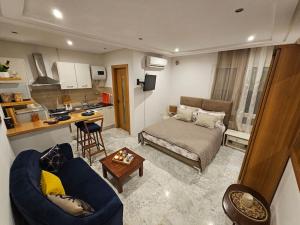 a small living room with a couch and a kitchen at Sweet Memories in Sousse