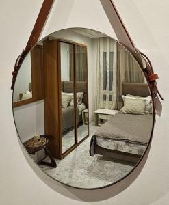 a mirror reflecting a bedroom with a bed in it at Sweet Memories in Sousse