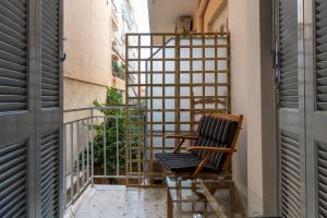 a balcony with a chair and a railing at Phaedrus Living: Luxury Studio Nea Smirni in Athens