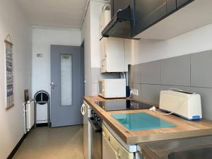 a kitchen with a sink and a counter top at Appartement Trégastel, 2 pièces, 4 personnes - FR-1-368-220 in Trégastel