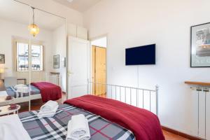 um quarto com 2 camas e uma televisão de ecrã plano em Monti Deluxe - Terrace Spectacular View em Roma