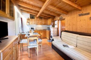 a living room with a couch and a table at Casa Colturi Abete in Valdisotto