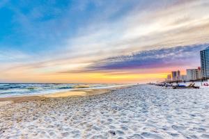 a beach with the ocean and buildings in the background at Palacio Condominiums II in Perdido Key