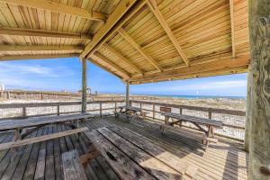 a wooden deck with benches on the beach at Palacio Condominiums II in Perdido Key