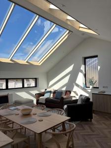 a living room with skylights and a person sitting on a couch at Coastal Retreat, Torquay - Anstey Cottage in Torquay