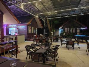 a restaurant with tables and chairs and a piano at Stay 7 Jomtien Resort in Jomtien Beach