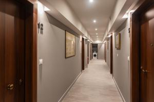 a hallway with a row of doors and a long corridor at Au Piree by Calon in Piraeus