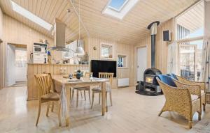 a kitchen and living room with a table and chairs at Beautiful Home In Sjllands Odde With Wifi in Tjørneholm