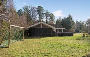 a house with a soccer goal in a field at Beautiful Home In Sjllands Odde With Wifi in Tjørneholm