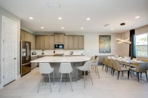 a kitchen and dining room with a table and chairs at Encore Resort 6 Bedroom Vacation Home with Pool 1913 in Orlando
