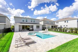 a backyard with a swimming pool and a house at Encore Resort 6 Bedroom Vacation Home with Pool 1913 in Orlando
