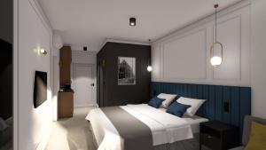 ビャウィストクにあるApartamenty Branickaのベッドルーム1室(ブルーアクセントの大型ベッド1台付)