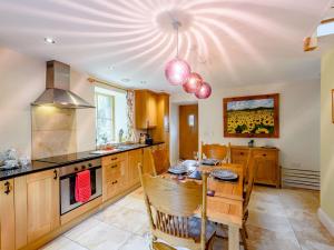 a kitchen with a table and a dining room at 2 Bed in Conwy 74147 in Eglwys-Fâch