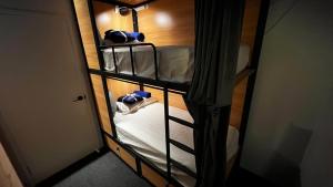 מיטה או מיטות קומותיים בחדר ב-Capsuleaccom Hostel