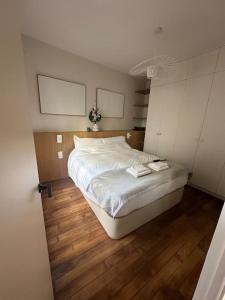a bedroom with a bed with two towels on it at Cosy Apt 4P-porte maillot -palais des congrés in Paris
