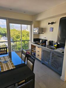 a kitchen and dining room with a view of the city at Apartamentos Centricos in Mendoza