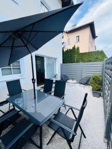 a table and chairs with an umbrella on a patio at Apartment M4 in Salzburg