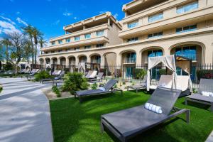 a row of lounge chairs in front of a building at Grand Hyatt Indian Wells Resort & Villas in Indian Wells