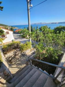 a set of stairs with a view of the ocean at Guest House Karlobag - Villa Rose in Karlobag