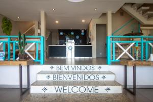 a lobby with a staircase with a welcome sign at Pousada Aroma do Mar by Latitud Hoteles in Búzios