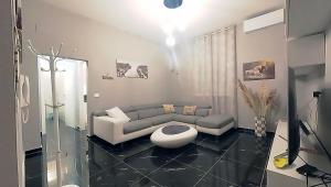 uma sala de estar com um sofá e uma mesa em Tra centro e mare - Intero appartamento con parcheggio em Savona