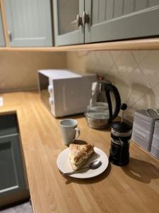 a piece of food on a plate on a kitchen counter at Grand Mill: Near to Shops, Attractions, Restaurant in Burton upon Trent