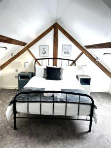 een slaapkamer met een zwart-wit bed op een zolder bij Grand Mill: Near to Shops, Attractions, Restaurant in Burton upon Trent