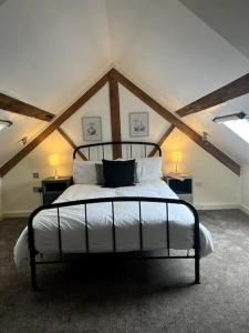 a bedroom with a large bed in a attic at Grand Mill: Near to Shops, Attractions, Restaurant in Burton upon Trent