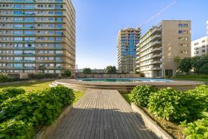 a walkway in a city with tall buildings at WHome Luxury Living by the Sea: Matosinhos Marvel in Matosinhos