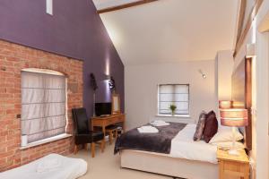 a bedroom with a bed and a desk with a computer at Finest Retreats - Nether Burrows Farm in Ashbourne +15 photos